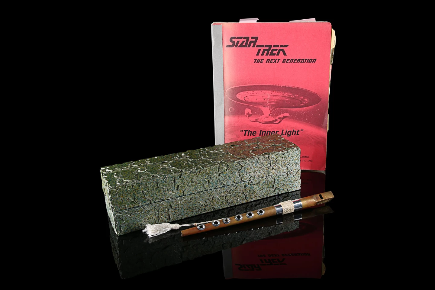 This collection of Jean-Luc Picard's (Patrick Stewart) Ressikan Flute, Box and Costume Continuity Script from "Star Trek: The Next Generation" (T.V. SERIES, 1987 - 1994) was sold for $237,500 at Propstore on 1 July 2021