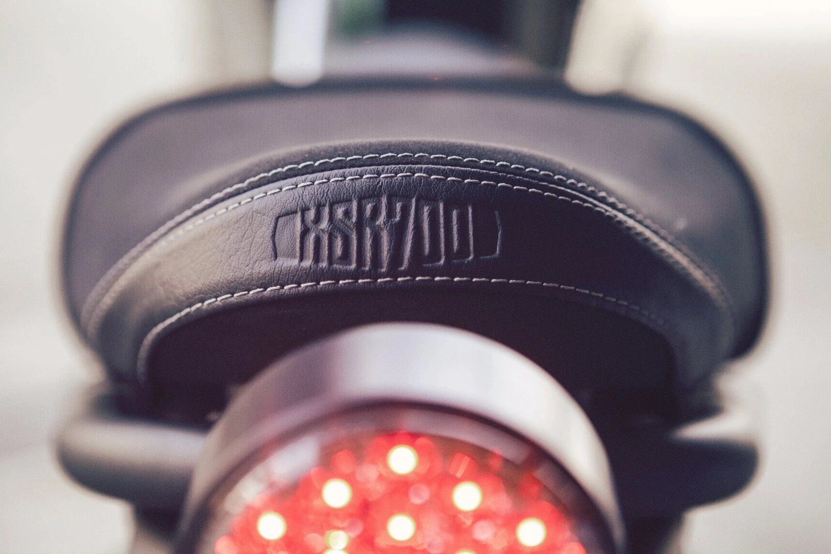 The vintage style seat has a sculpted XSR700 logo on the back. The round tail light uses modern LED technology