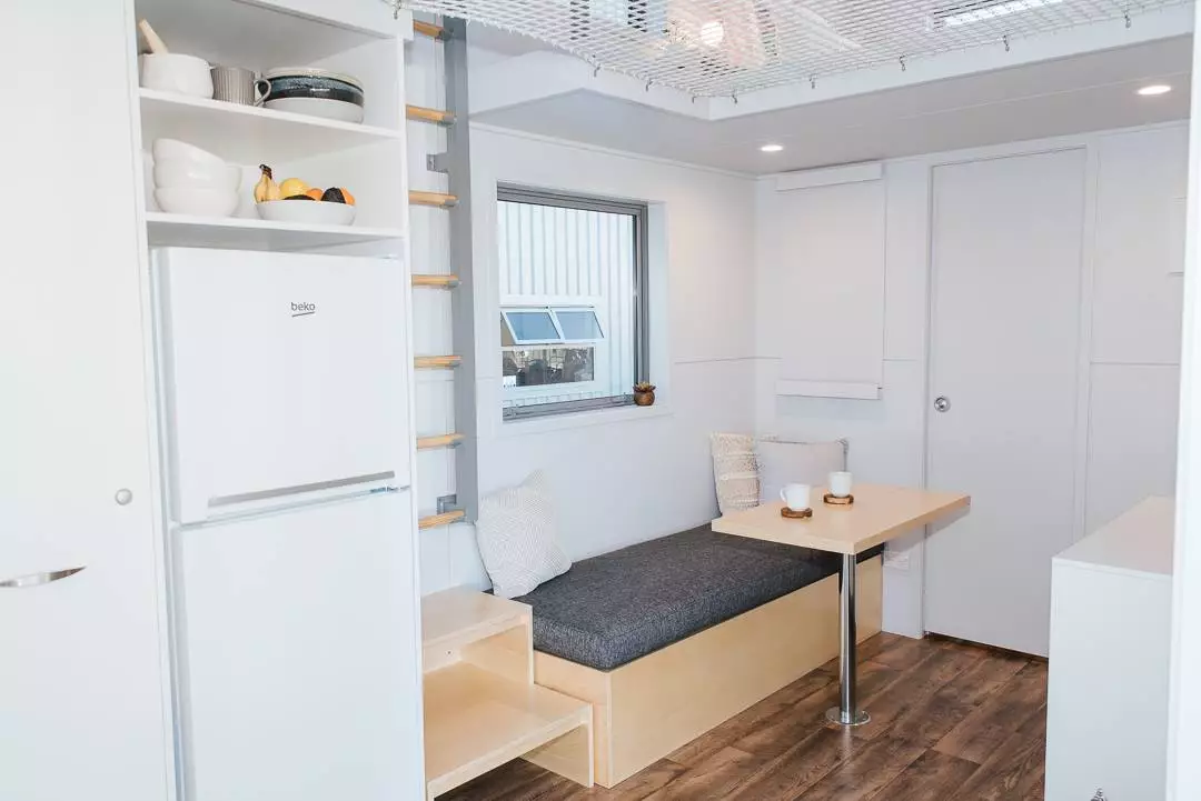 The Larissa and Tyler Tiny House's living room includes a removable table