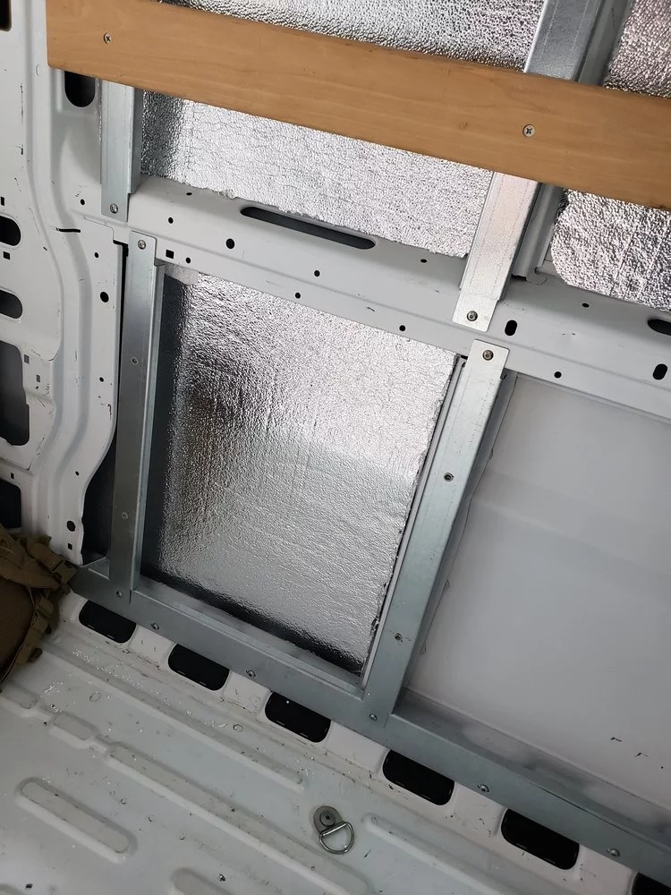The couple bought styrofoam insulation and foil liner from Home Depot to insulate the bare walls of the van