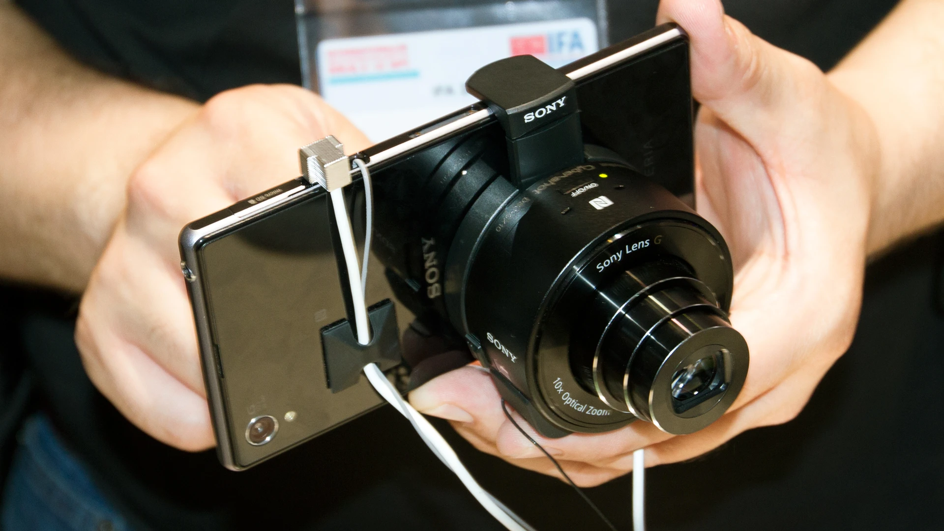 The QX100 is one of two new add-on cameras that can be mounted on mobile devices, such as the new Xperia Z1