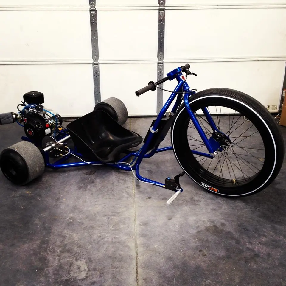 The trike is set in motion with a twist throttle fixed to the aluminum bars