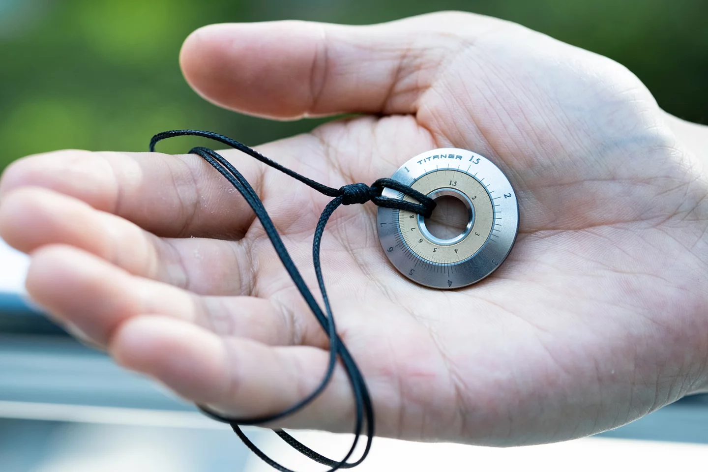 The Mini Titanium Curve Measure Slide Rule can also be worn as a nerdy pendant