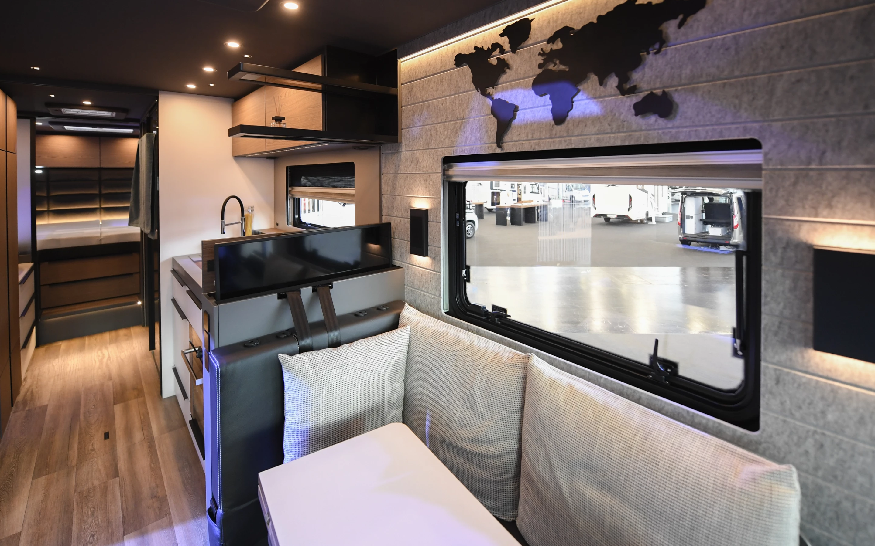 The optional television lifting out of the wall next to the sofa