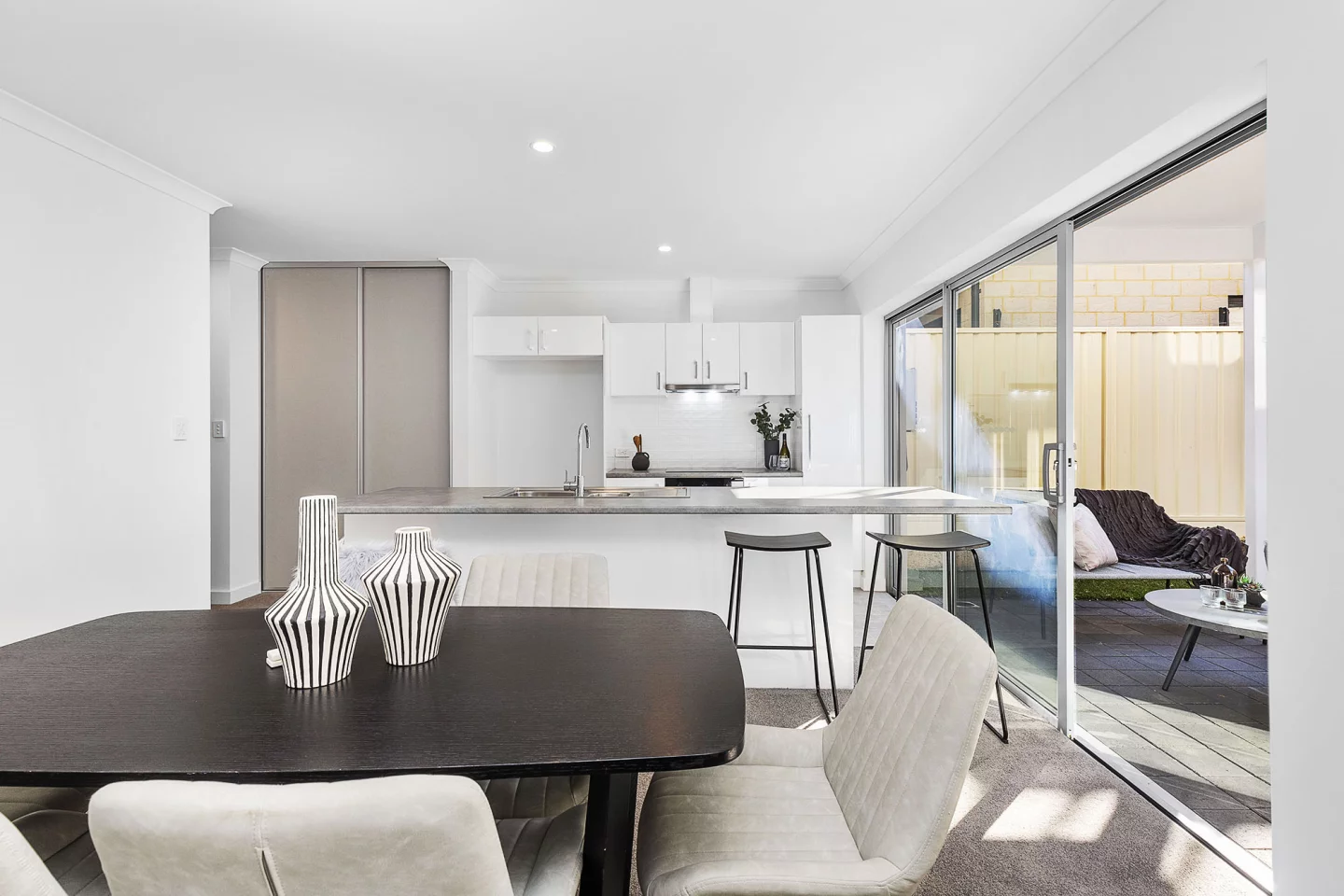 The 3D-printed house has generous glazing, helping fill the interior with daylight