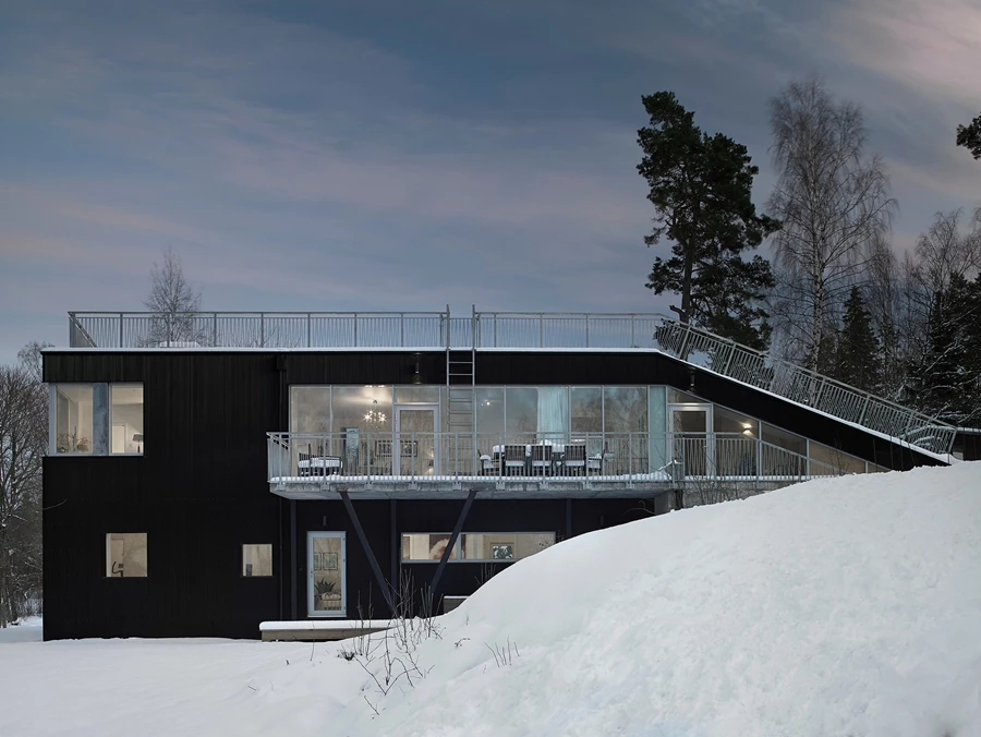 Inside the Pulkabacken House, floor-to-ceiling windows provide views of the sea