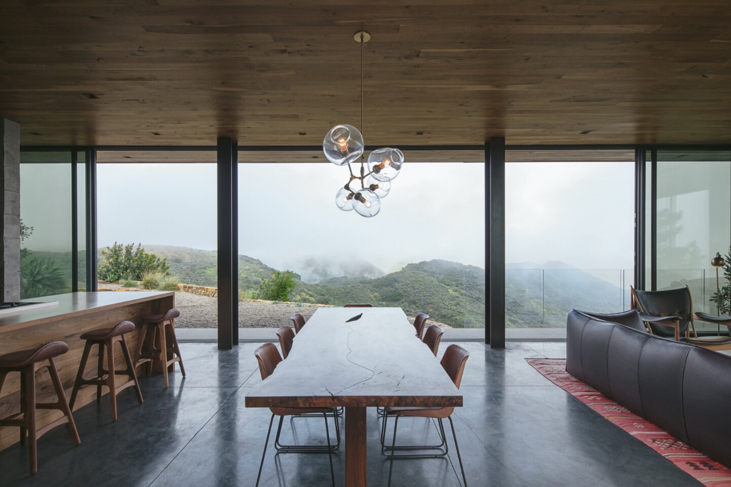 The Off-Grid Guest House is kept a comfortable temperature with a combination of radiant floor heating, cross ventilation from the operable sliding glass, a pellet burning stove, and an insulating green roof