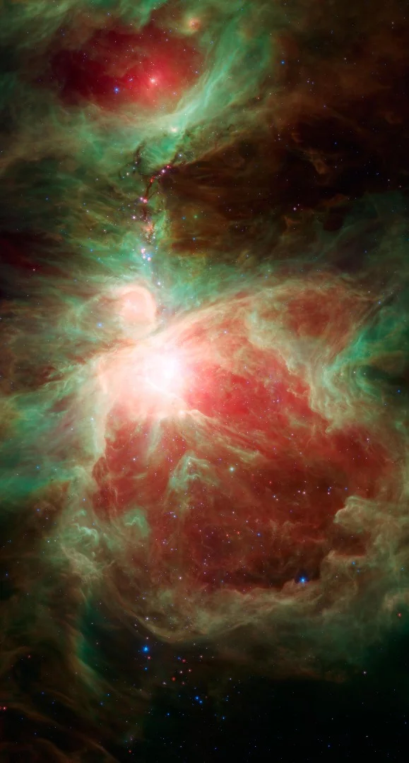 The Orion nebula, seen here as the bright region in the center of the image, is an active stellar nursery near the “sword” of the constellation Orion.