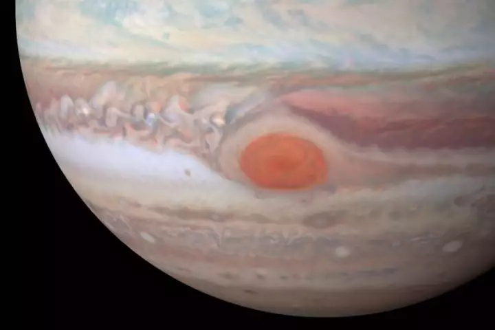 Juno is set to swoop low over Jupiter's Great Red Spot, a massive storm that's been raging for centuries, to probe its mysteries