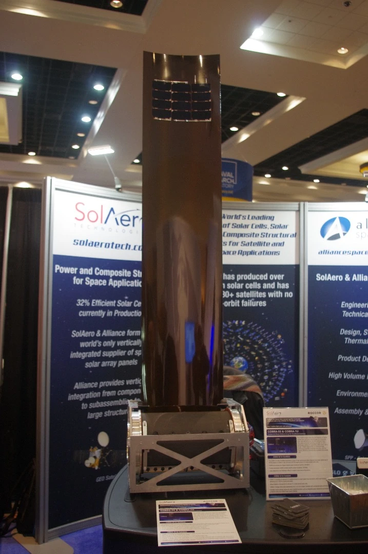 The COBRA-SS rollout array from SolAero. Made from a mix of a flexible blanket and rigid panels, this system can be attached to a satellite to provide a source of power. It travels in a compact canister and, when it's time to start grabbing energy from the sun, the panels can simply be rolled out like a shade on a window.