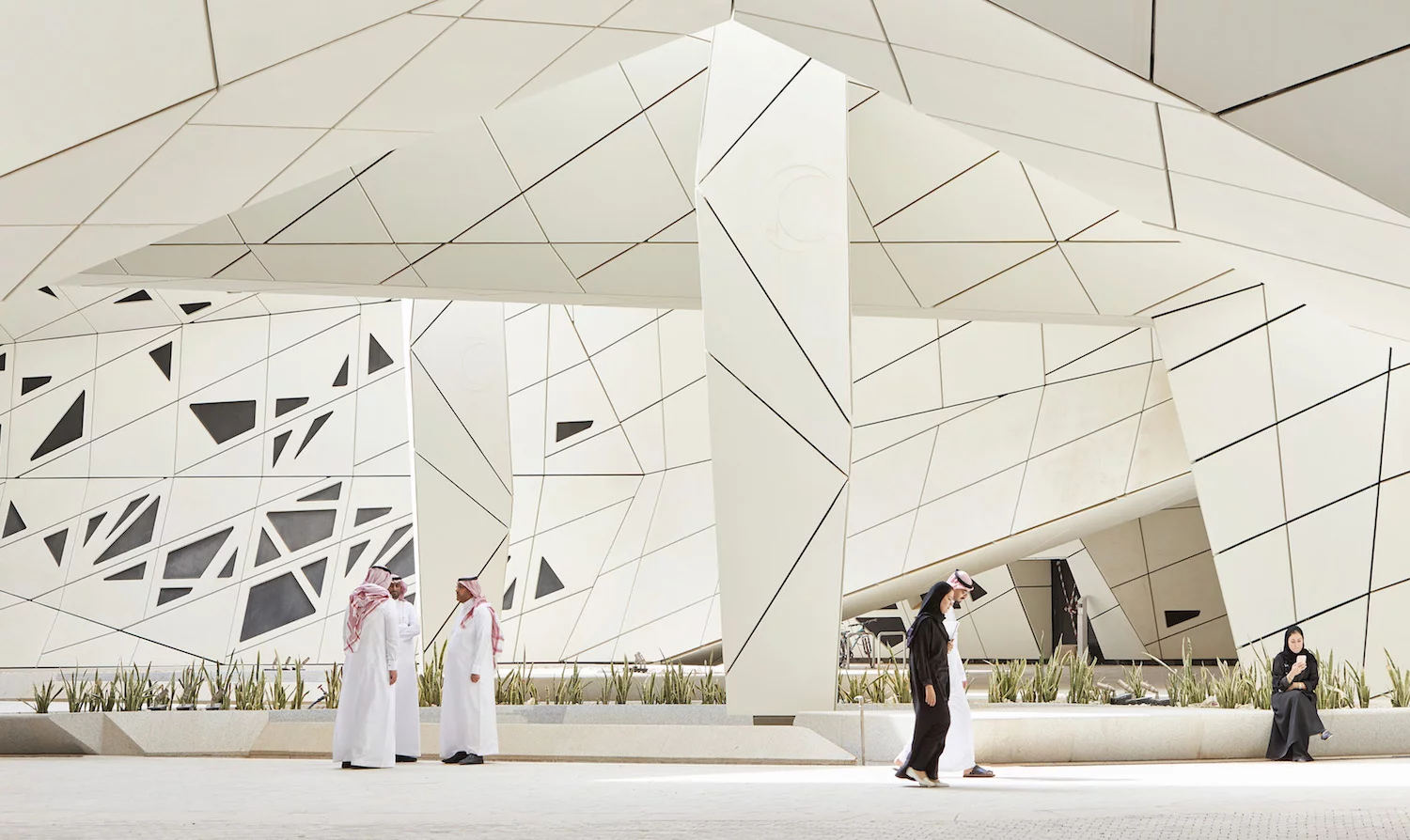 KAPSARC's buildings are interconnected, with shared public spaces, and take the form of hexagonal prismatic honeycomb structures arranged around a large public courtyard shaded by canopies
