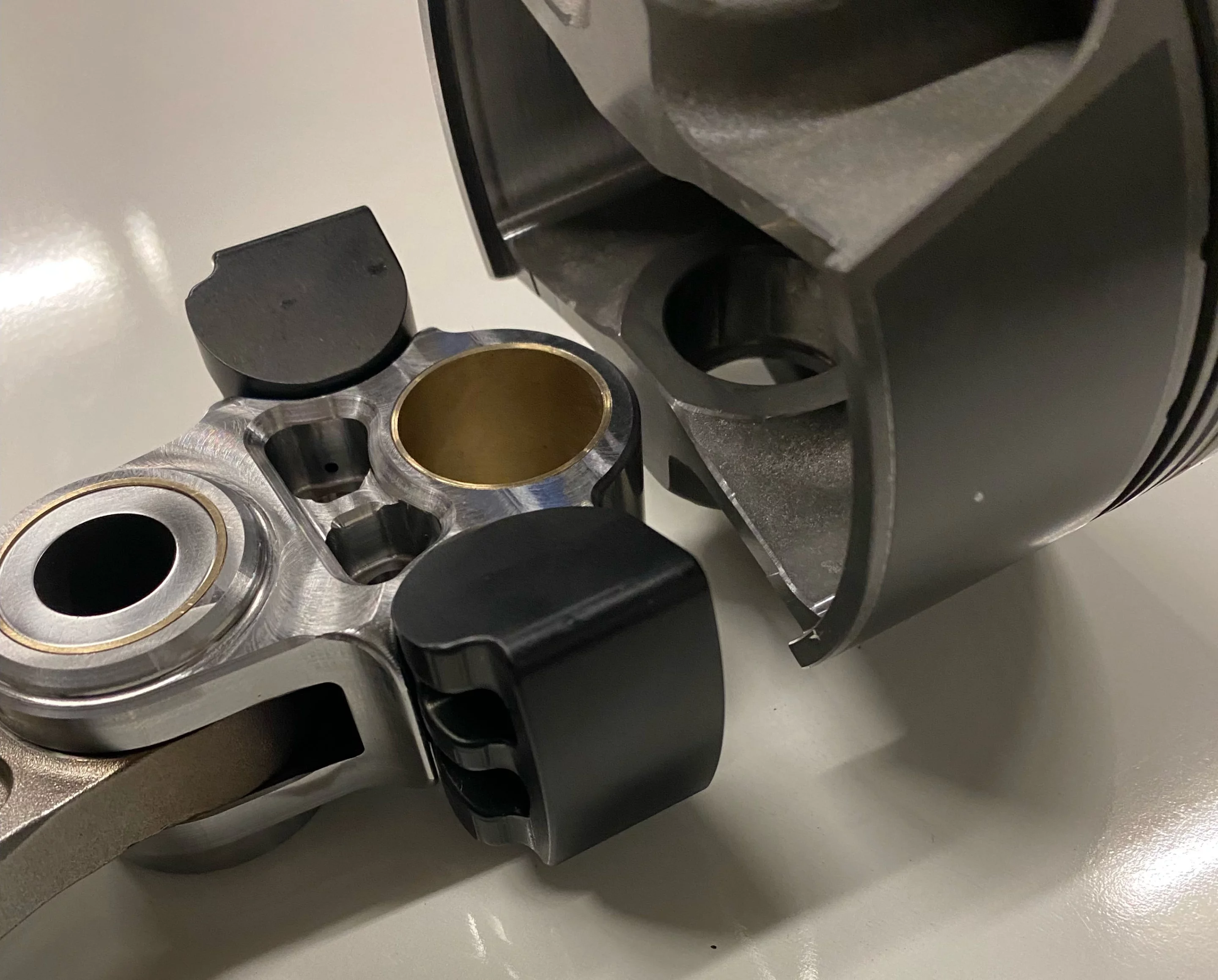 Saddles in the sides of the upper section of the Thunder Rods actively engage the sides of the piston skirt when installed