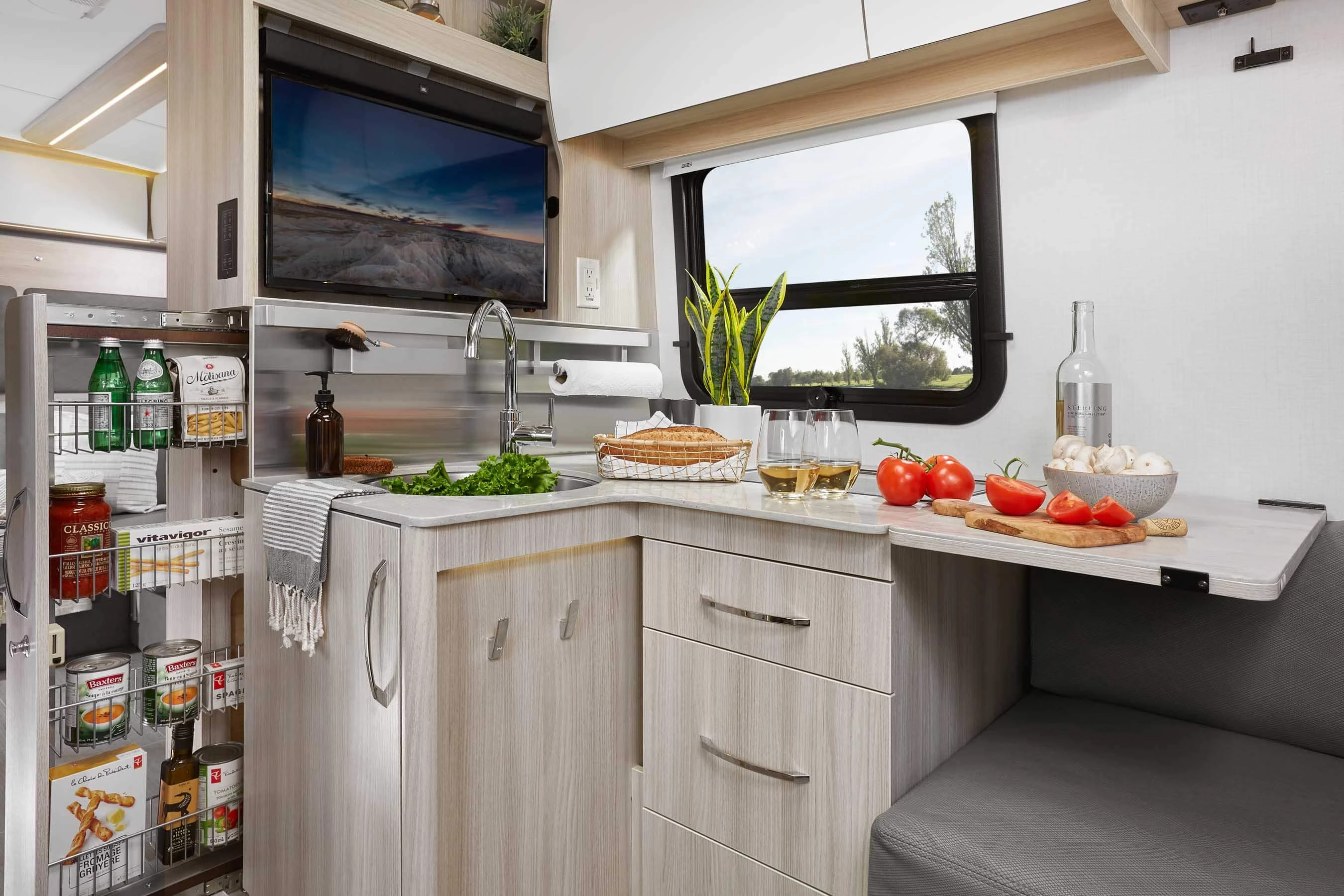 The kitchen includes a flip-up counter extension and slide-out pantry