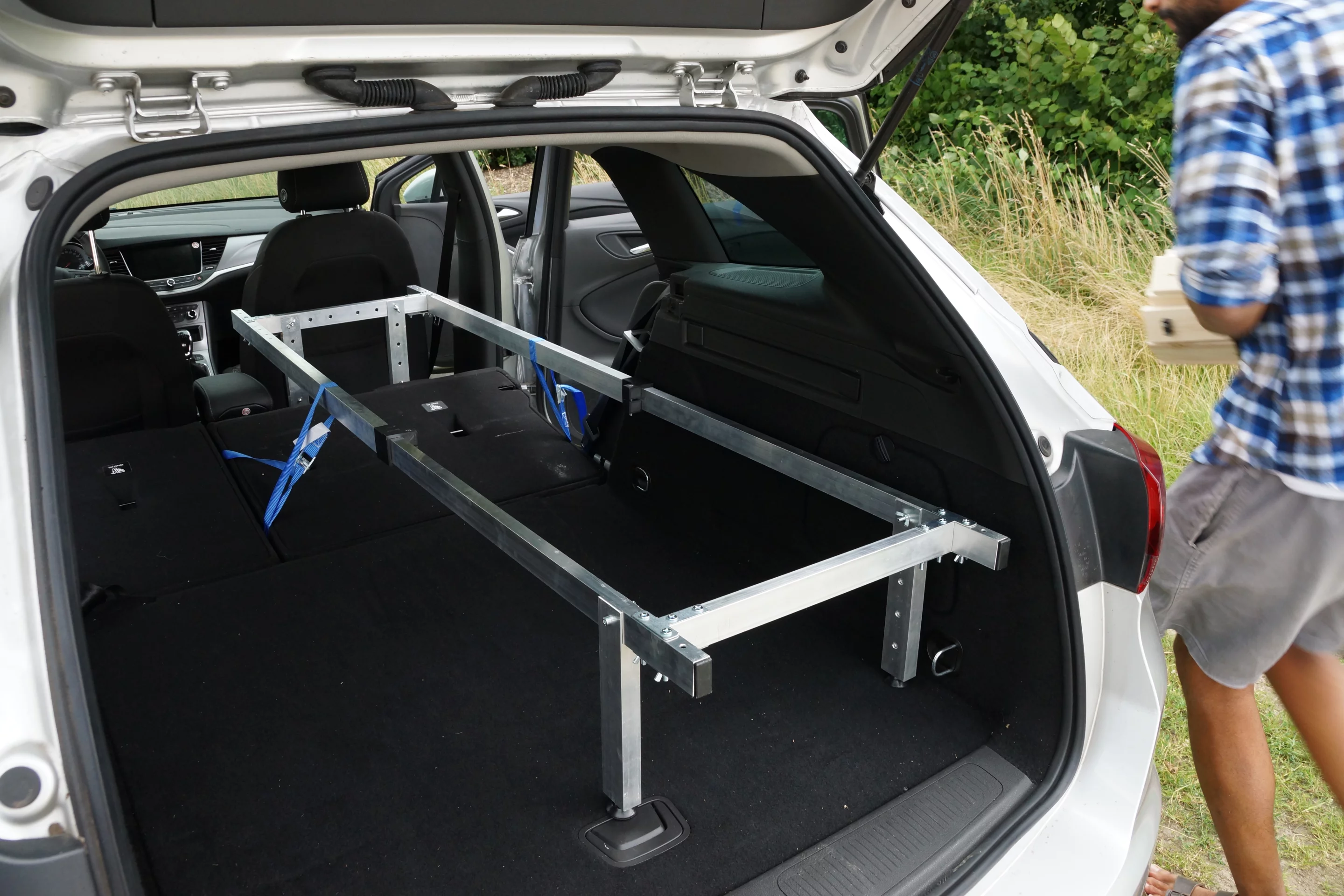 The aluminum frame adjusts around different vehicle lengths and layouts, strapping down to provide a stable night of sleep