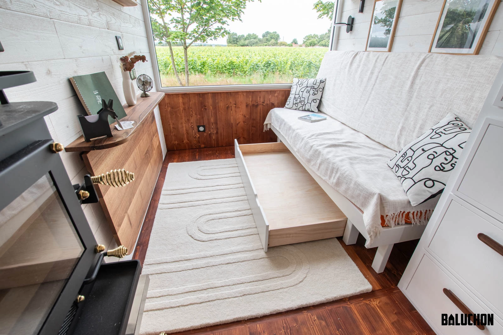 The Moulinsart's living room/bedroom includes some storage space under the sofa bed, as well as shelving