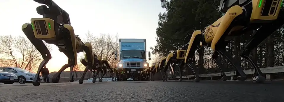 Ten SpotMini bots pull a small truck