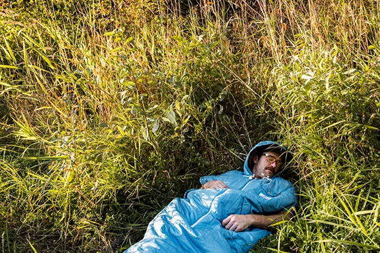 When you want to sleep, zippers at the bottom convert the Napsack from hoodie to sleeping bag