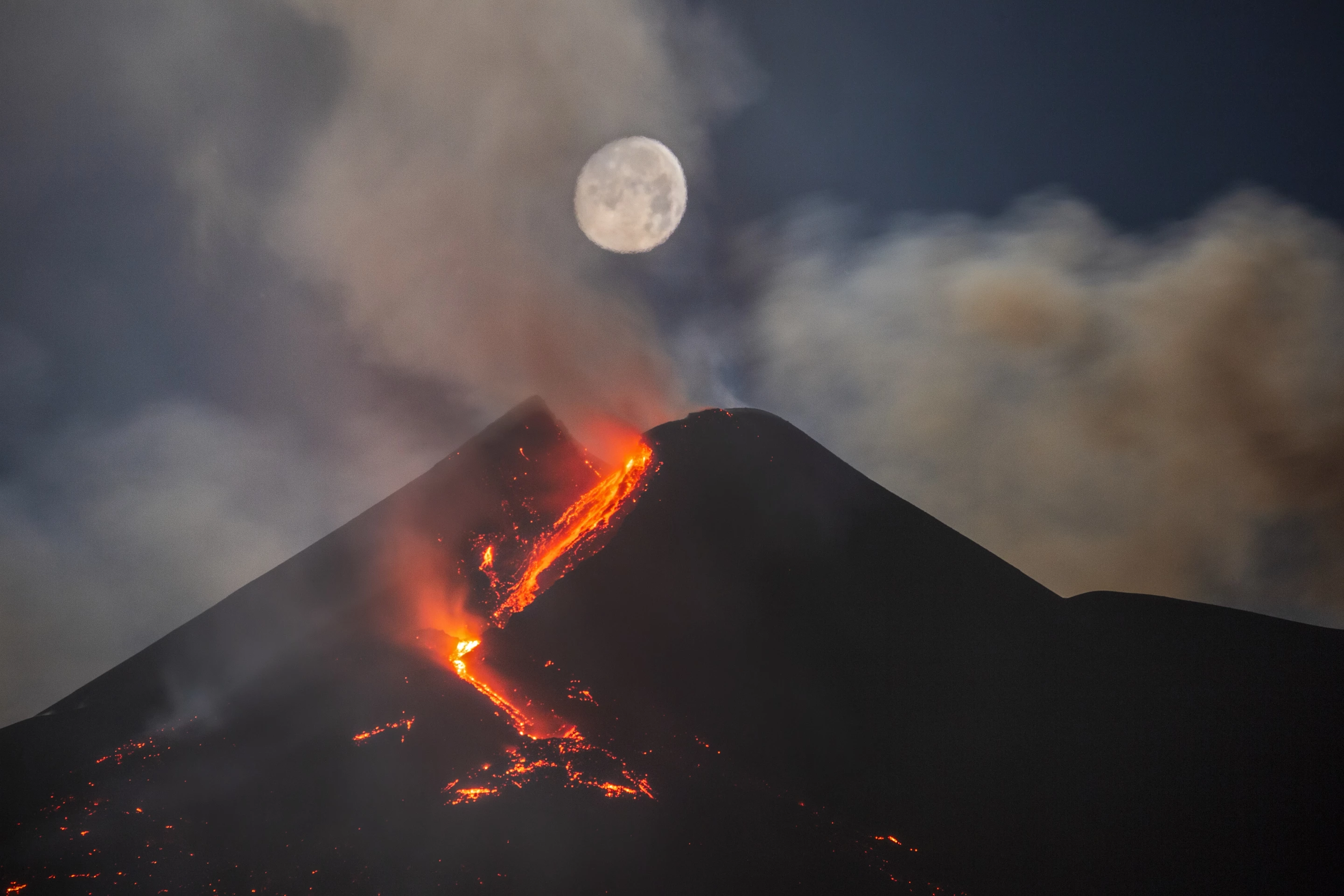 Runner Up - Skyscapes. Moon Over Mount Etna South East Crater. Milo, Sicily, Italy. Canon EOS 6D camera, Sigma 150–600 mm lens at 347 mm f/5.6. Foreground: ISO 800, 5-second exposure. Moon: ISO 100, 1/125-second exposure