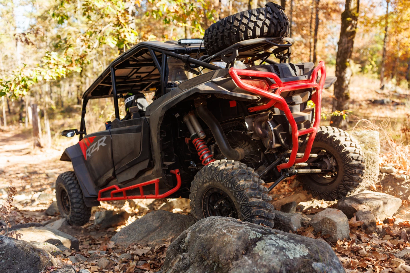 Accessories for the 2024 Polaris RZR XP include this articulated spare tire rack and modified rear bumpers and rock rails