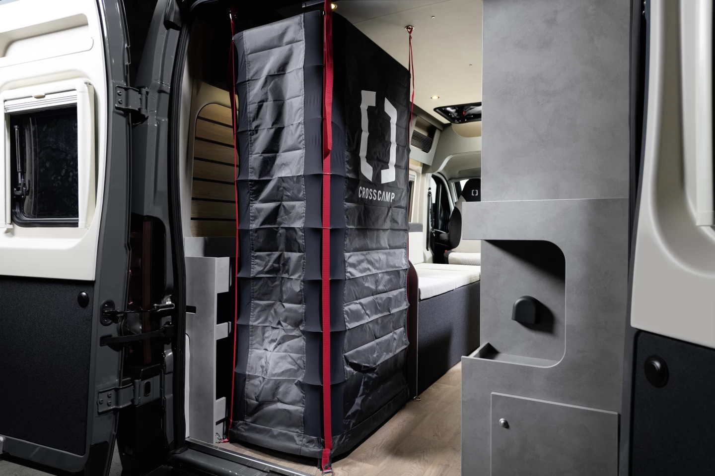 No mention of a toilet, but the Crosscamp Flex 541 does offer a quick-deploying shower that gets out of the way when not in use