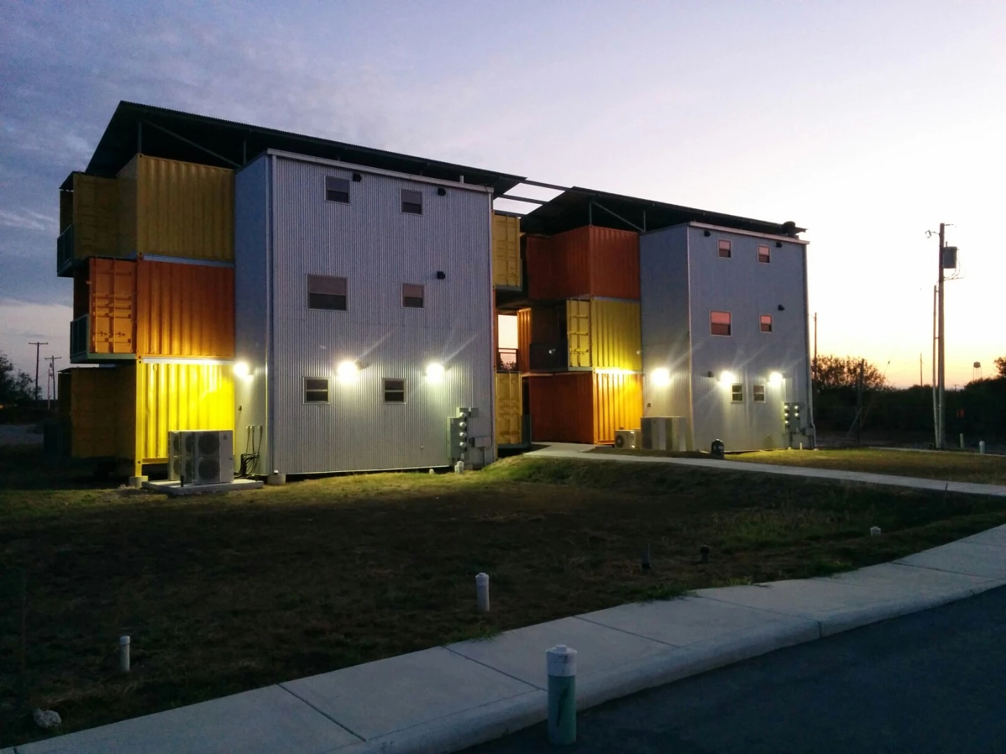 The containers are based within a prefabricated framework which adds stairs, patios, and additional rear sections