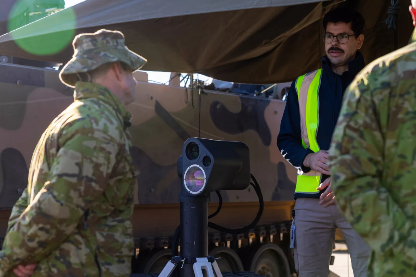 AIM Defence co-founder Dr Jae Daniel explains the operation of the AIM Defence Counter-UAS Directed Energy Weapons System to Australian Army Director General Future Land Warfare Brigadier James Davis