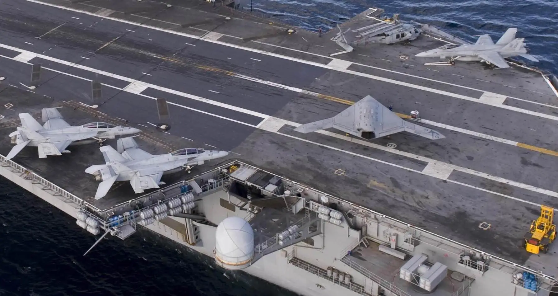 The relative size of the X-47B to manned fighters (Photo: U.S. Navy MC3 Kristina Young)