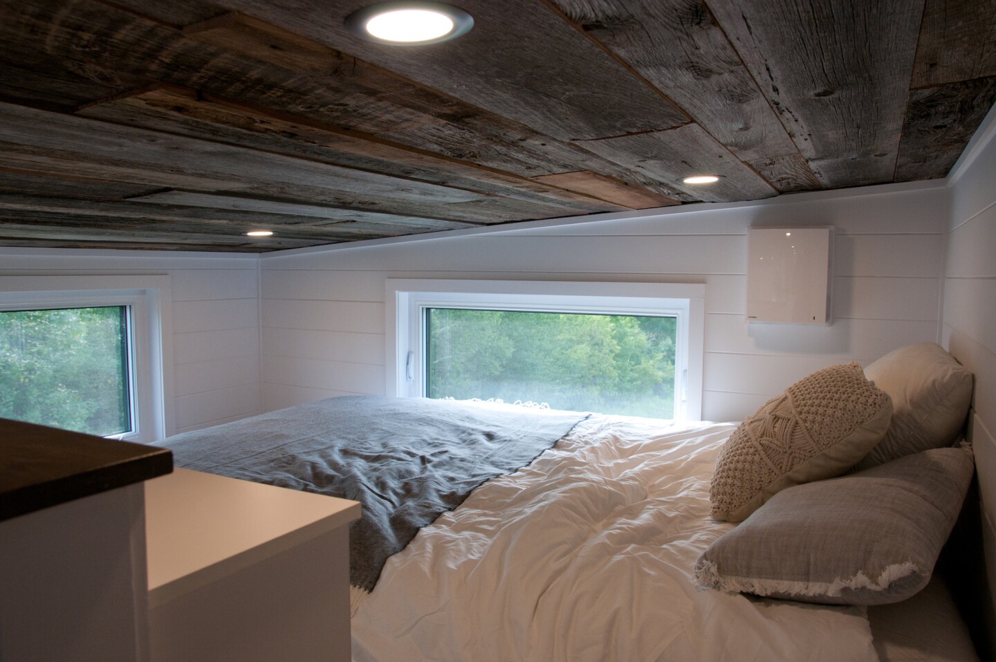 The Baobab's bedroom only loft bedroom, with the low ceiling typical of tiny houses