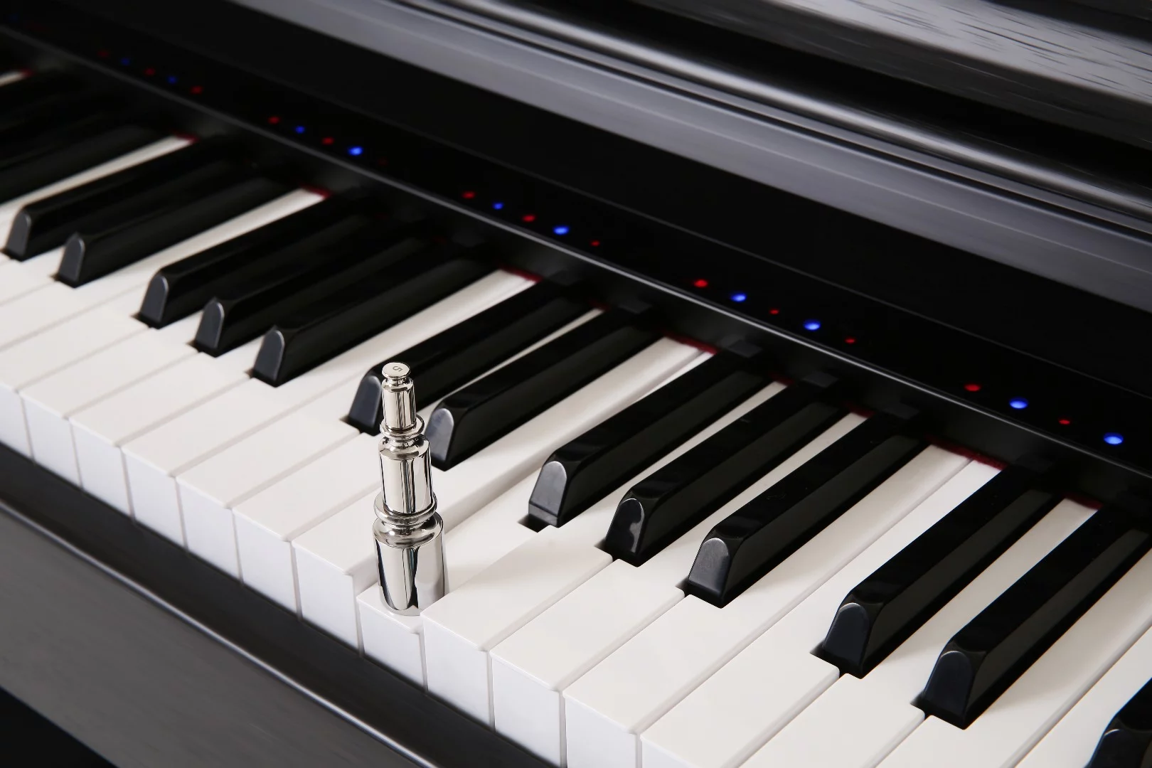 The One Smart Piano features a strip of LEDs that syncs with the 88 hammer-weighted keys with a synthetic ivory feel