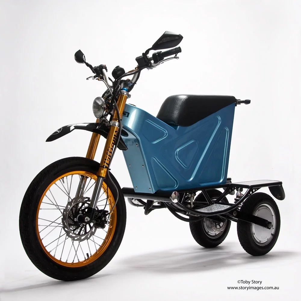 The prototype electric Deliver E-Trike has independently-pivoting rear swing arms, which allow it to stand upright when parked on grades