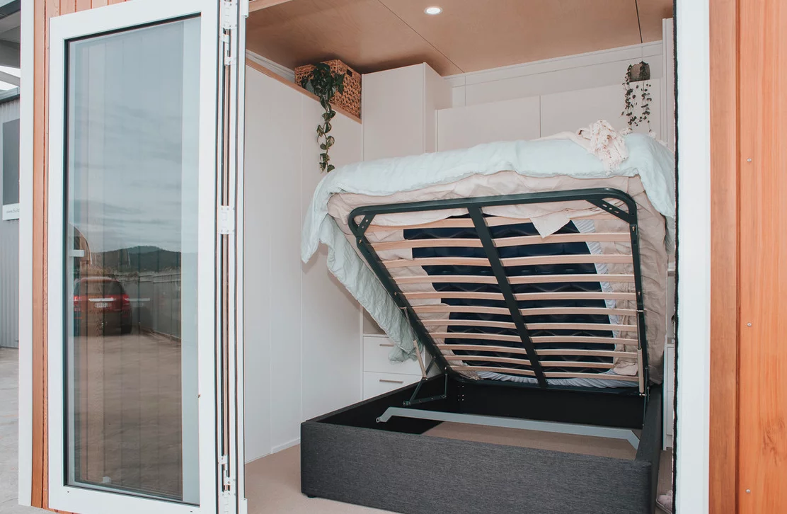 The Kōtuku's bedroom contains a storage-integrated bed, and opens up to the outside