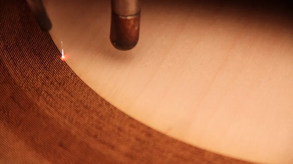 After obtaining a round piece of wood, a laser cutter sliced the tiny bumps and grooves of the record using the vector file as a guide
