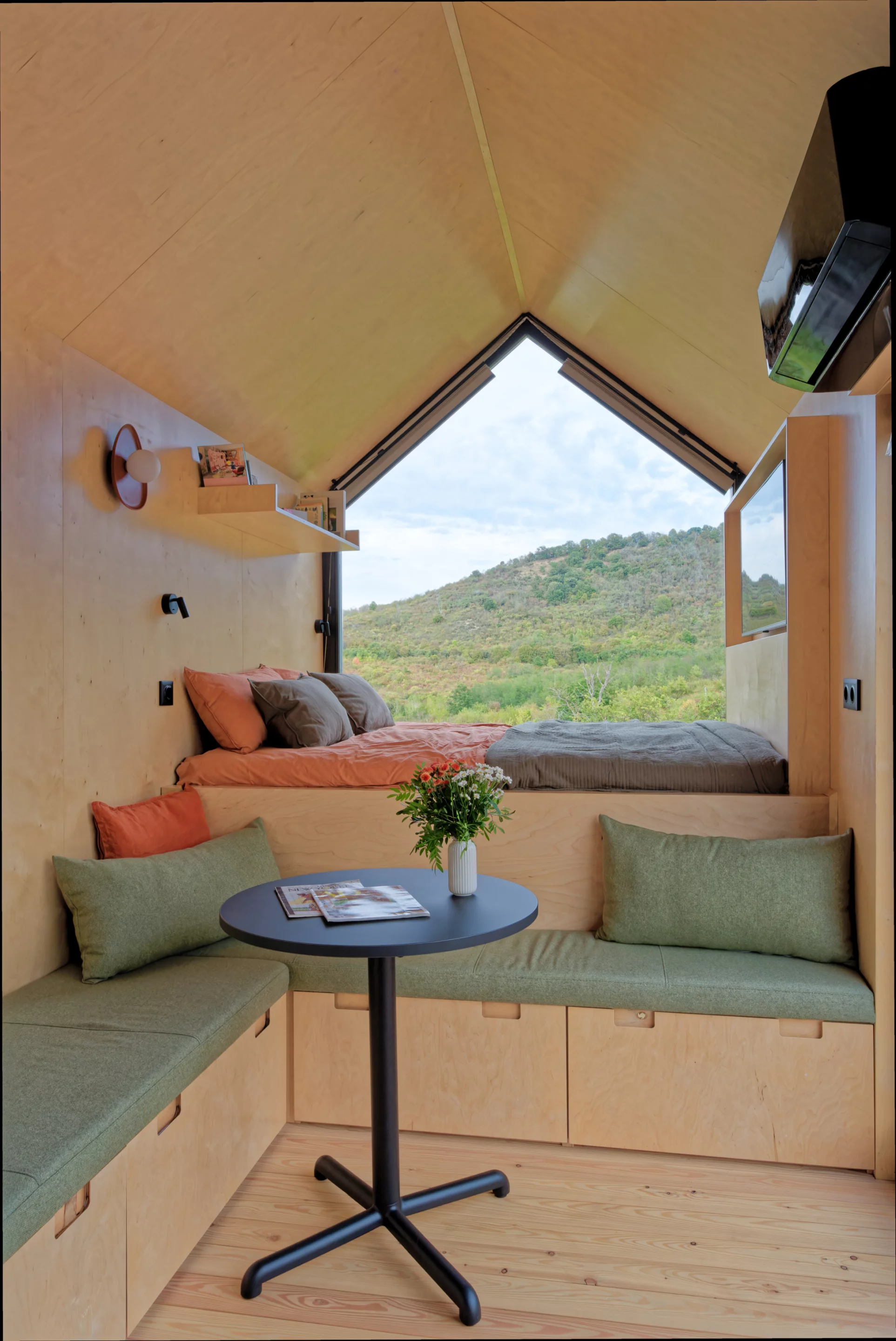 The NestOff’s living area includes a large L-shaped sofa with integrated storage, plus a coffee table