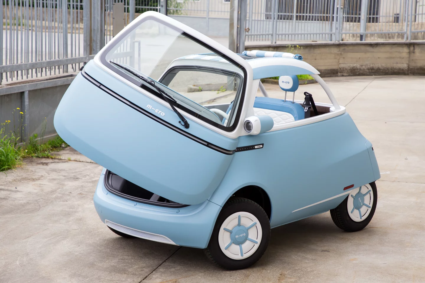 The Microlino Spiaggina electric micro car features a fabric sunroof and open back/sides