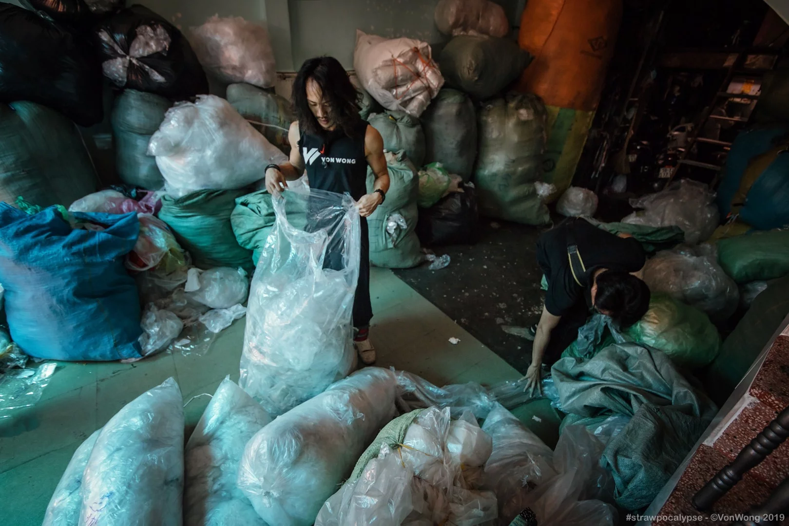 Canadian artist Benjamin Von Wong at work on his Strawpocalypse installation