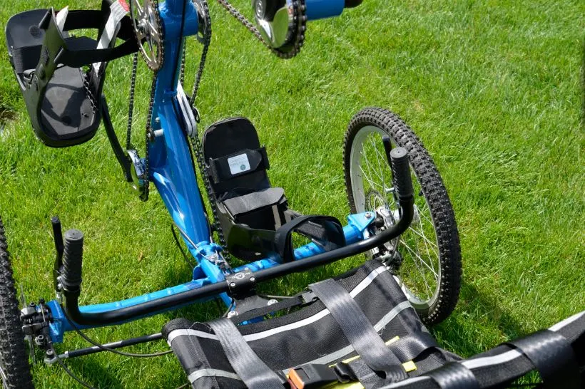 The TheraTryke's hand crank moves the cycle, but also moves and stretches the rider's legs