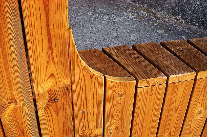 Vertical wooden panels wrap around the structure