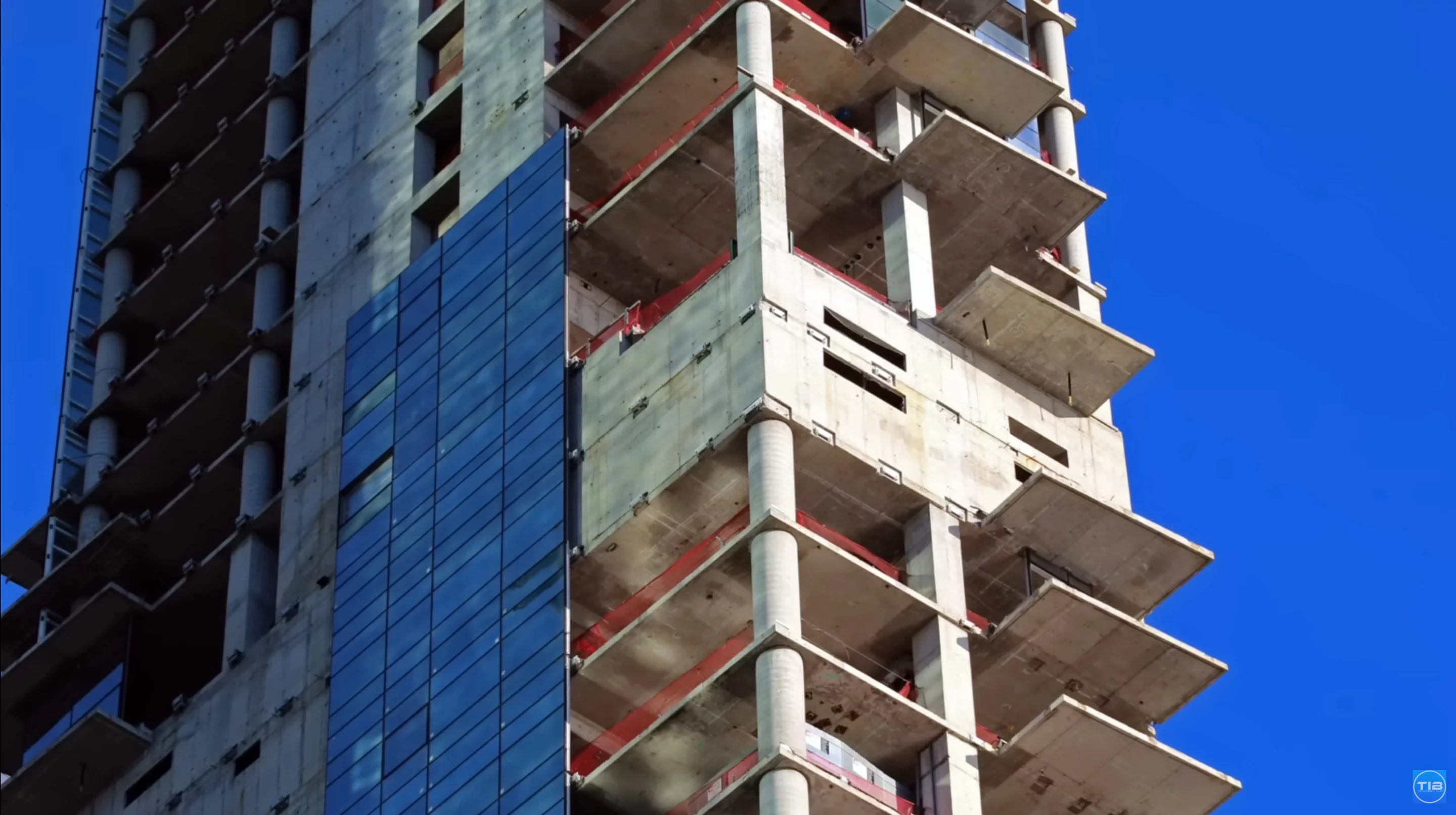 For years the building has stood unfinished, with no completion date in sight – due to its irregular shape and lean, panels from the glass facade have fallen or broken