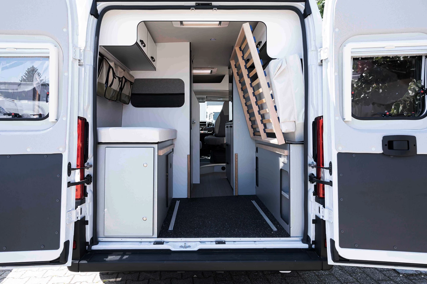 The bed folds out of the way for gear loading