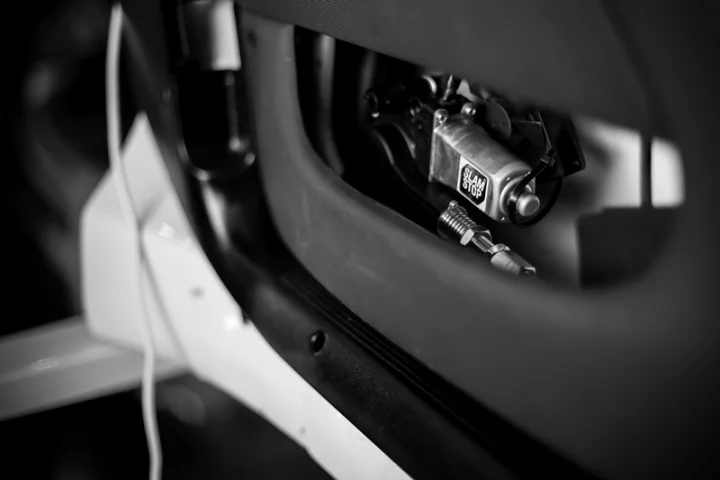 A cut-away view of a car door with the Slamstop device installed