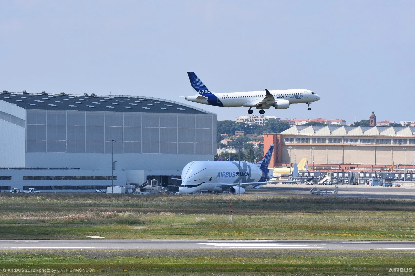 The A220-300 passing over an Airbus Beluga