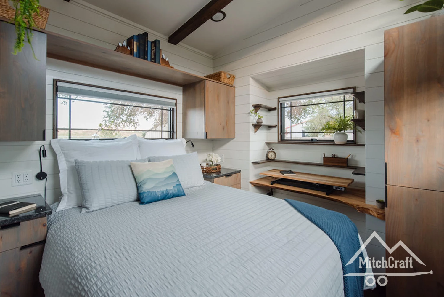 Lisa's 30 x 10 Tiny Home's main bedroom includes a double bed and a home office area
