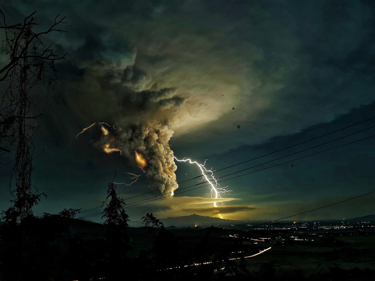 Honorable Mention, Nature. Streaks of lightning blazed through columns of ashes amid Taal Volcano’s eruption as seen from Nasugbu, Batangas, Philippines