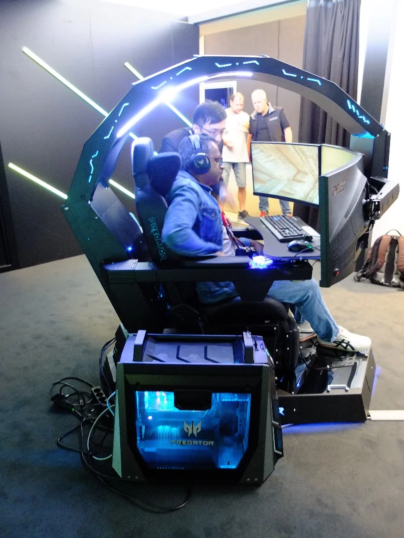 As you take a seat in the chair, you press a button to lower your bank of displays