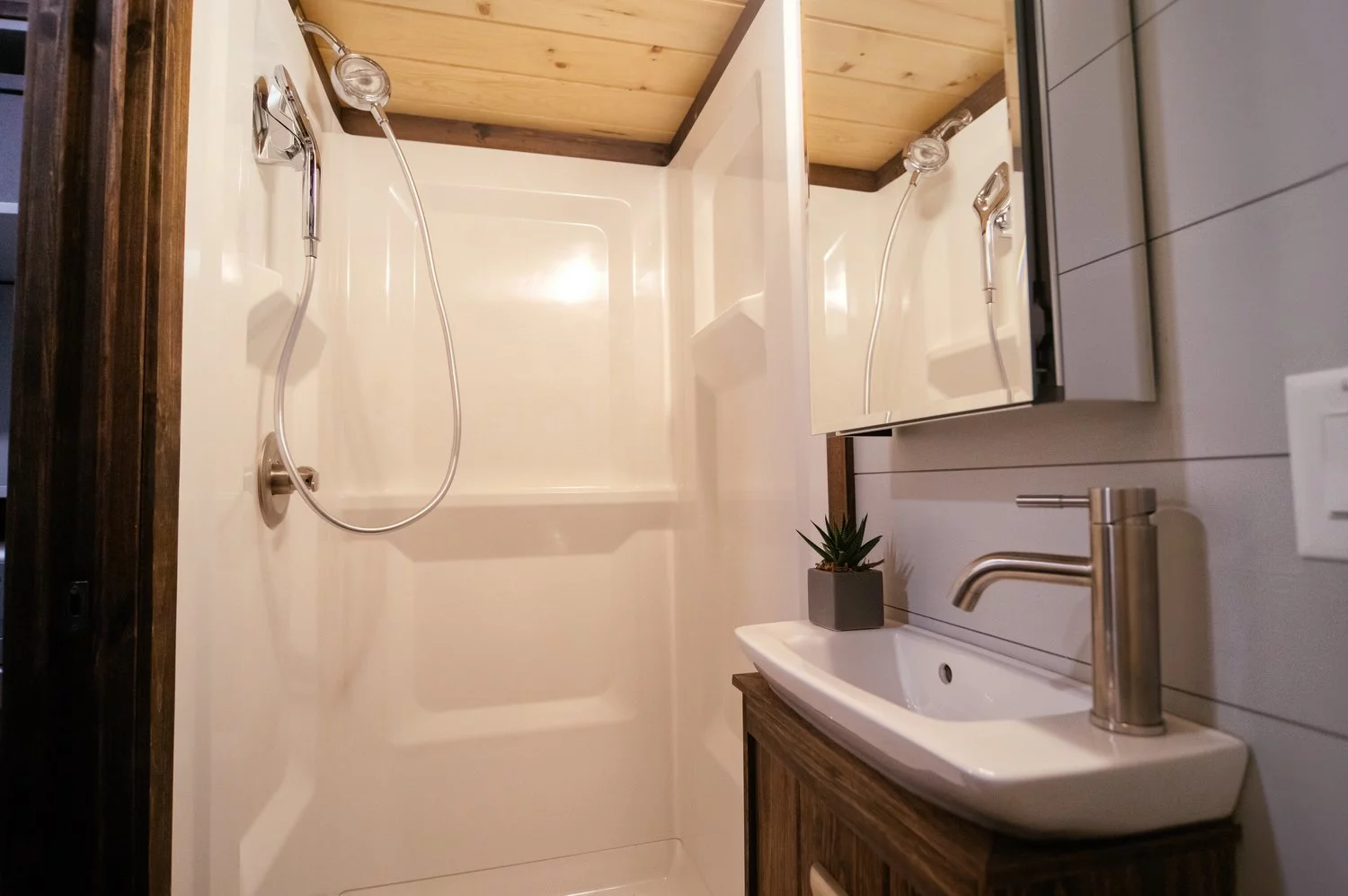 The Lykke's bathroom includes a shower, toilet, and small sink