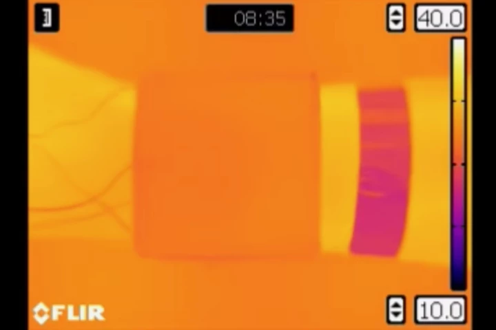An armband made of the material (imaged in orange) changes temperature to match its environment