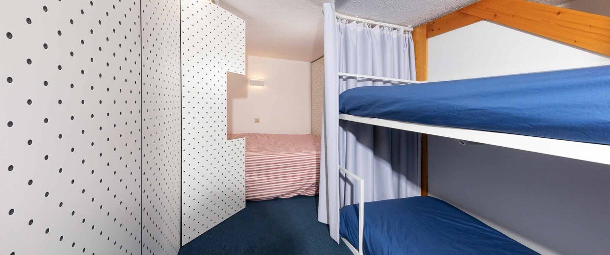 The elevated mezzanine level has been enhanced to include a hidden double bed and refurbished original single bunk beds