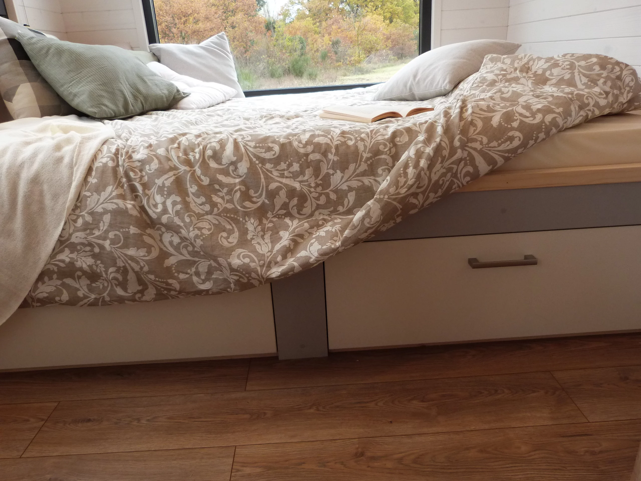 The Capucine's bedroom includes a double bed with integrated storage space