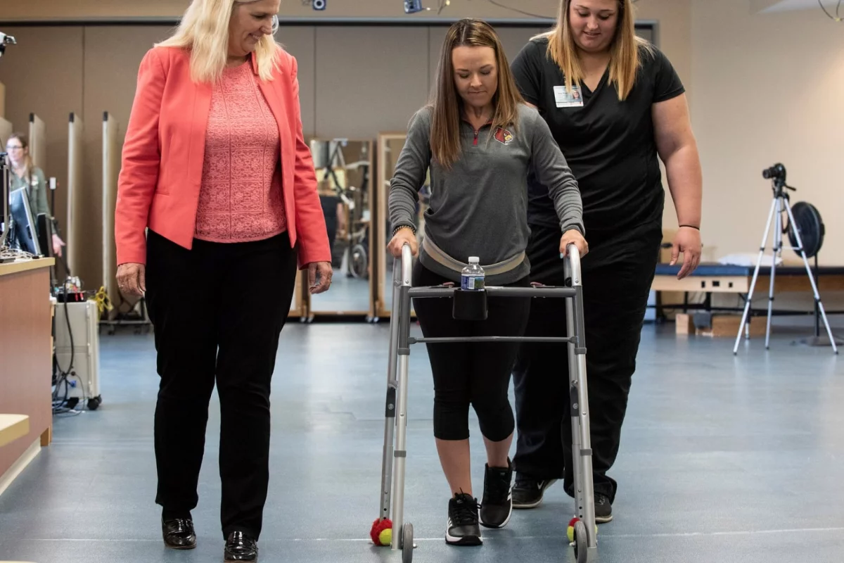 Kelly Thomas (center) walks independently after success with the new groundbreaking treatment