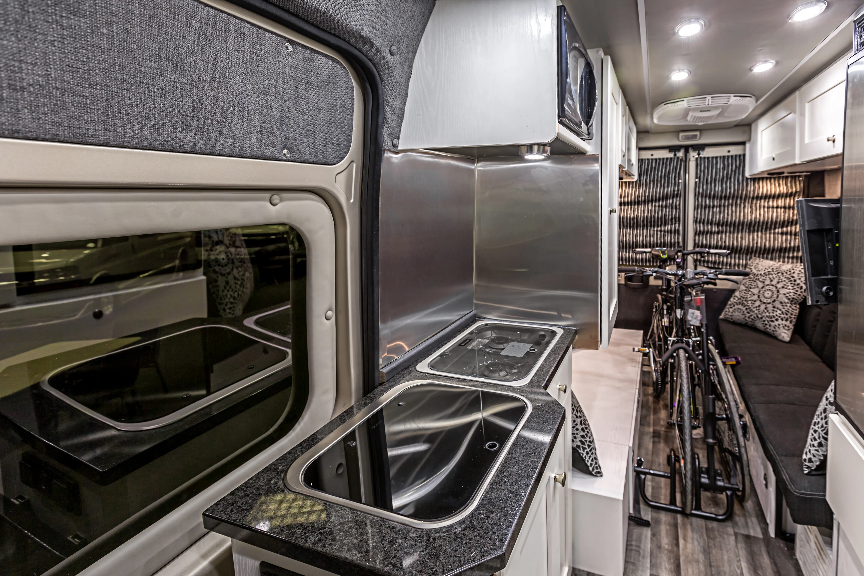 The Zion includes a kitchen with propane stove, microwave and refrigerator